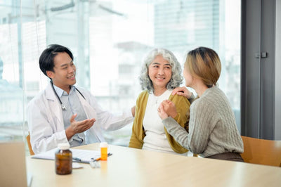 Doctor consulting with two patients in a bright clinic setting