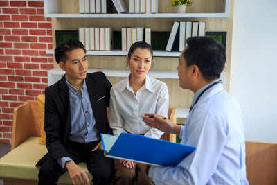 Doctor discussing with a couple in an clinic setting