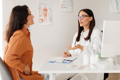 Doctor and patient having a conversation about woman's health in a medical office setting.