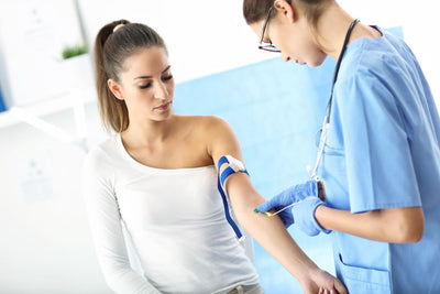 Woman receiving an injection from a healthcare professional in a clinical setting