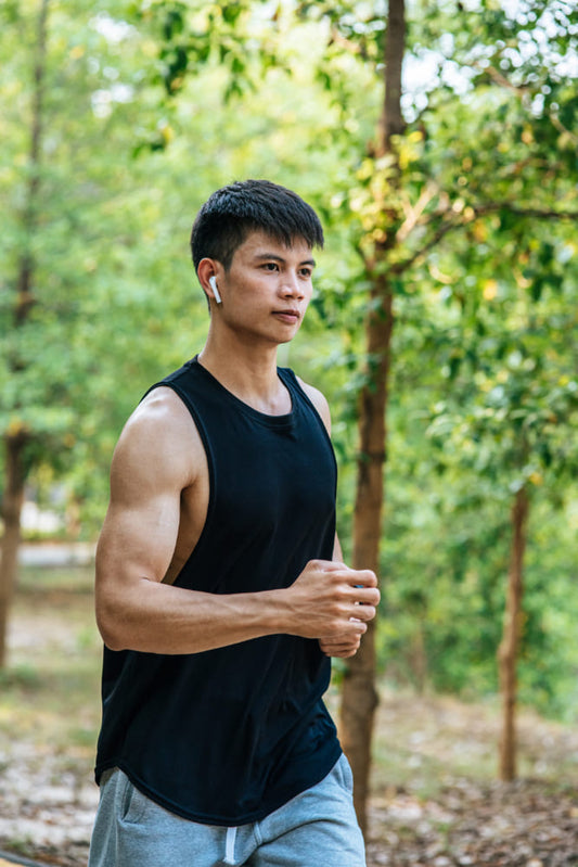 Man exercising outdoors with greenery in the background