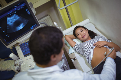Doctor performing an ultrasound on a patient in a medical setting