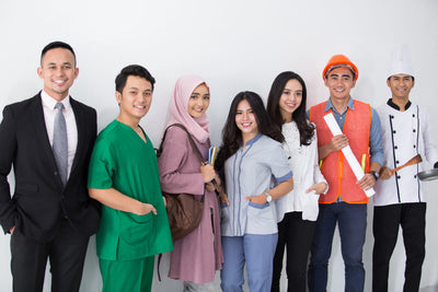 Group of people in various attire standing together  and different profession against a white background