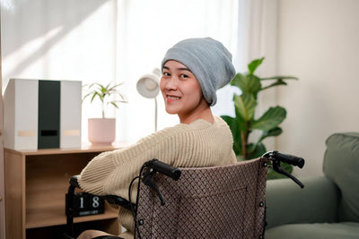 Person sitting in a wheelchair with a cozy indoor setting