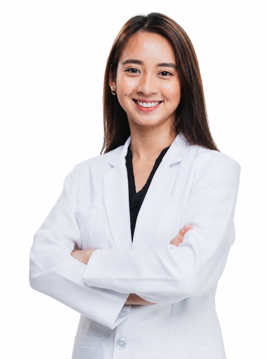A smiling woman with long brown hair wearing a white medical lab coat over a black top, standing with arms crossed against a plain white background.